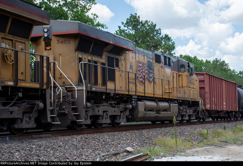 UP 5402 trails on a unit tank car train